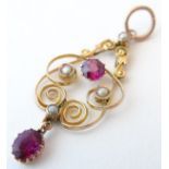 An Art Nouveau 9ct gold pendant set with garnet and seed pearls, maker W. Bros. Approx.