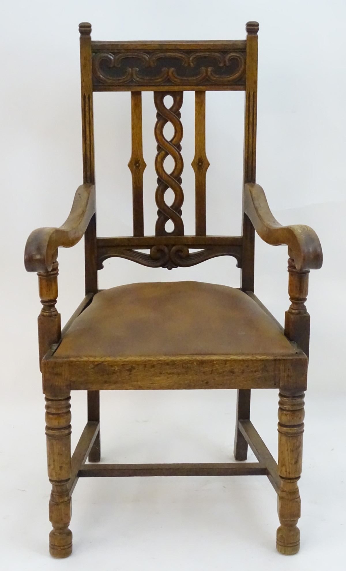 An early 20thC oak open armchair with a Celtic style carved top rail and back ress, - Image 5 of 8