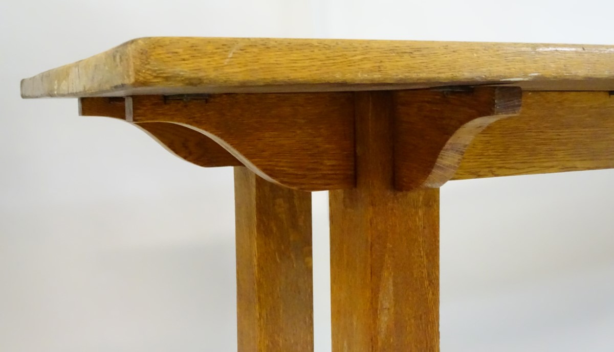 An early 20thC large Arts & Crafts style oak dining / refectory table with a rectangular top above - Image 7 of 9