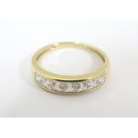 A 14ct gold ring set with 7 cubic zirconia in a linear setting. Ring size approx.