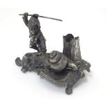 A Novelty silver taper stick stand the base formed as a gnome and a snail. Maker K & Co.