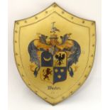 A 20thC tin plate heraldic shield wall plaque,