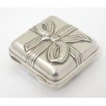 A novelty Greek silver box formed as a present / gift with ribbon decoration and opening to reveal