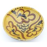 A 19thC slipware bowl with stylised foliate decoration. Approx. 2 ½” high x 7 ½” diameter.