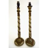 A pair of carved wooden table lamps, each decorated with moulded,