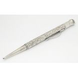 A silver propelling pencil with engraved decoration 4 3/4" long CONDITION: Please
