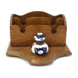 A 19thC wooden letter rack and standish with a pen rest and Imari style ceramic inkwell with floral