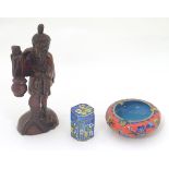 Three assorted oriental items, to include a carved figure with a fish and hanging pot,