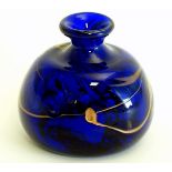 A studio glass vase with blue and bronze coloured swirl decoration.