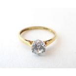 An 18ct gold ring set with a cubic zirconia solitaire. Ring size approx.