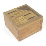 A small wooden box with marquetry inlay decoration depicting a stylised house. Approx.