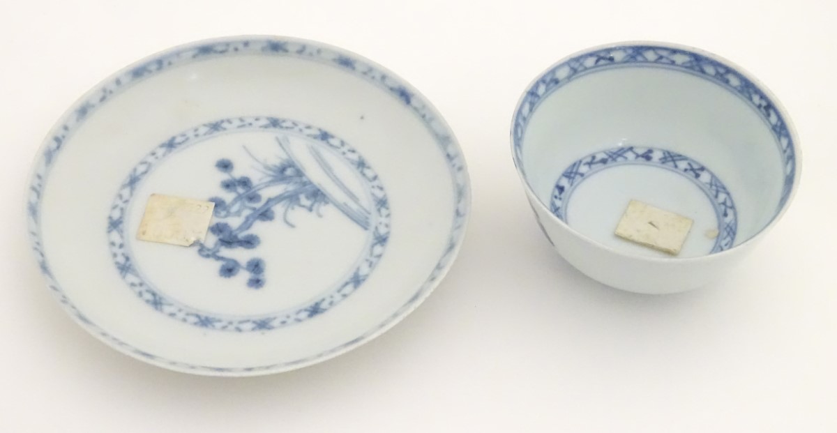 An 18thC Chinese Nanking Cargo blue and white tea bowl and saucer, decorated with pine trees. - Image 3 of 10