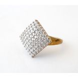A 9ct gold dress ring with a profusion of pave diamonds. Ring size approx.