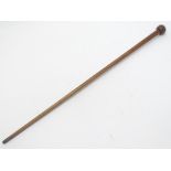 An early 20thC walking stick / cane with a trench art WW1 shell fuse top. Approx. 36'' long