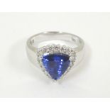 An 18ct white gold ring set with central iolite bordered by diamonds. Ring size approx.