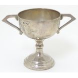 An Art Deco small silver trophy cup with twin handles. Hallmarked Birmingham 1931 maker