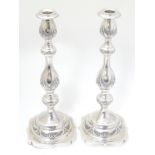 A pair of silver candlesticks with engraved decoration. Hallmarked London 1929 maker M.S.