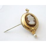 An Italian 8ct gold pendant / brooch set with central carved cameo and with pearl drop.