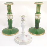 A pair of Bloor Derby candlesticks with acanthus and fluted columns with gilt highlights.