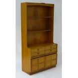 A mid / late 20thC teak wallboard dresser unit by Nathan Furniture,