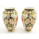 Two small Crown Derby Imari vases, with floral decoration and gilt highlights. Marked under. Approx.