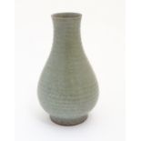 A Chinese celadon pear-shaped vase with a crackle glaze. Approx. 9 3/4" high.