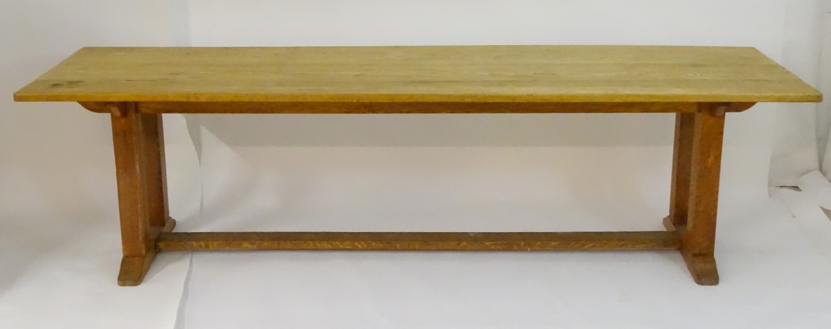 An early 20thC large Arts & Crafts style oak dining / refectory table with a rectangular top above - Image 9 of 9