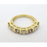 An 18ct gold ring set with diamonds and yellow stones in a linear setting Ring size approx.