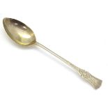 A silver teaspoon with engraved decoration. Hallmarked Sheffield 1907 maker John Sanderson.