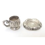 A Continental silver miniature dolls house cup and saucer.
