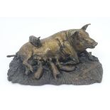 A bronze model of a recumbent pig with piglets on a base modelled as a bed of straw. Approx.