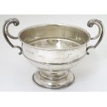 A large silver bowl with twin handles hallmarked Birmingham 1921 maker William Aitken.