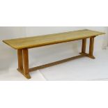 An early 20thC large Arts & Crafts style oak dining / refectory table with a rectangular top above
