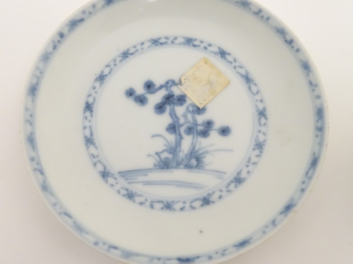 An 18thC Chinese Nanking Cargo blue and white tea bowl and saucer, decorated with pine trees. - Image 4 of 10