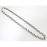 A silver long guard / necklace .