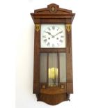 An Edwardian regulator wall clock, oak cased with decorative brass plates,