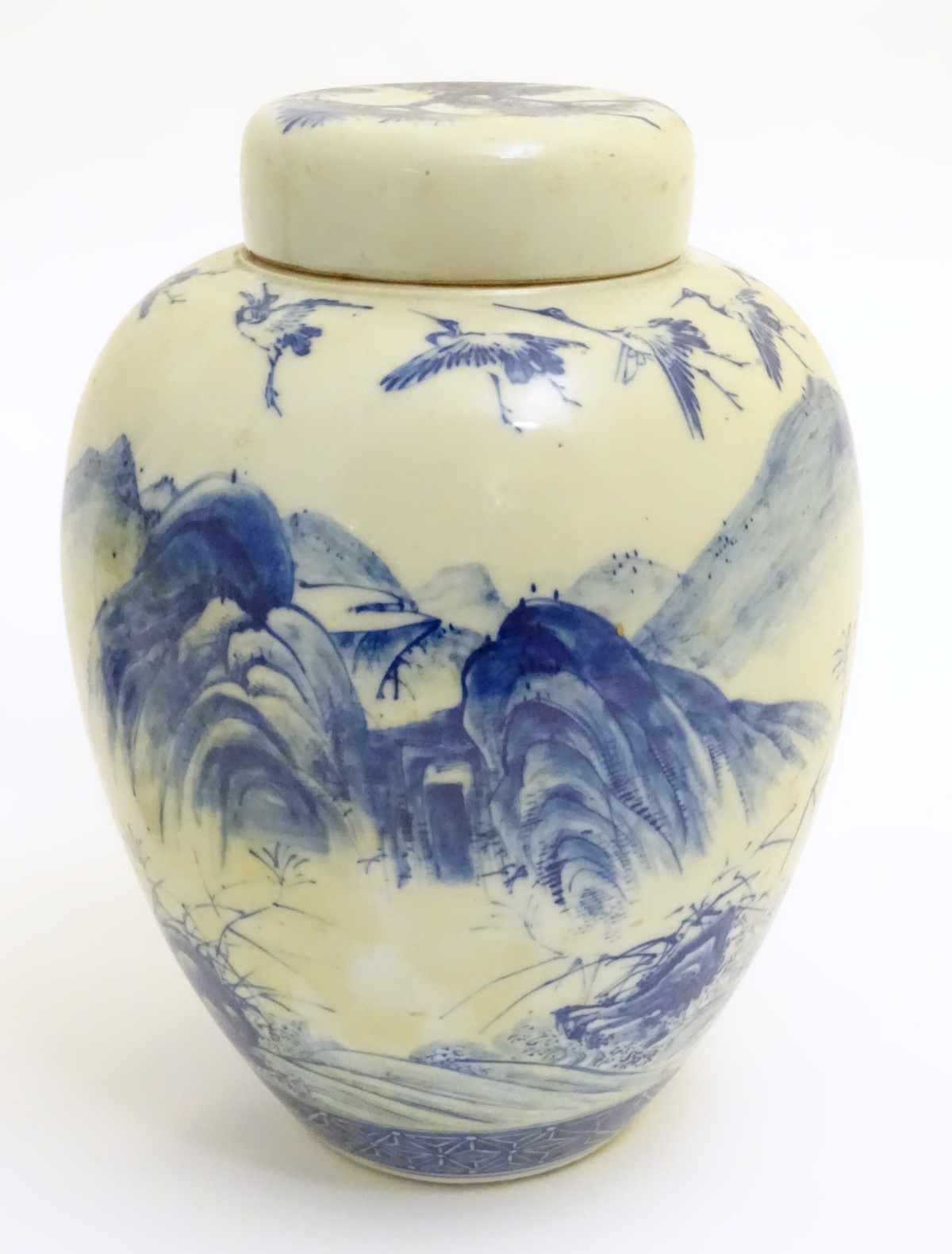 A large blue and white Japanese lidded ginger jar decorated with a sage sat by a tree in a - Image 3 of 7