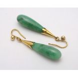 A pair of jade drop earrings with 9ct gold mounts. The earrings approx.