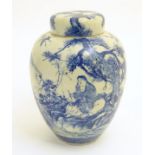 A large blue and white Japanese lidded ginger jar decorated with a sage sat by a tree in a