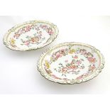 A pair of 19thC oval dishes with hand painted decoration of oriental style stylised scrolling