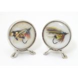 A pair of silver table place card/ menu holders set with fly fishing flies to centre.