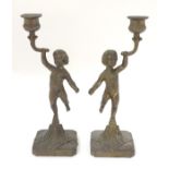 A pair of cast figural candlesticks. Approx.