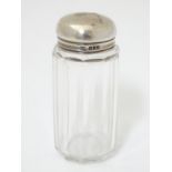A glass bottle with silver top hallmarked London 1906 maker Percy Whitehouse 3 1/2" high
