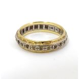 An 18ct yellow and white gold eternity ring set with band of diamonds. Ring size approx.