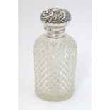 A hobnail cut glass scent / perfume bottle with silver mount and lid.