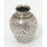 A Continental silver miniature vase with floral decoration.