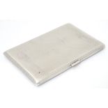 An Art Deco silver cigarette case with engine turned decoration.