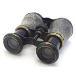 A pair of early 20thC binoculars, of brass construction with blacked finish.
