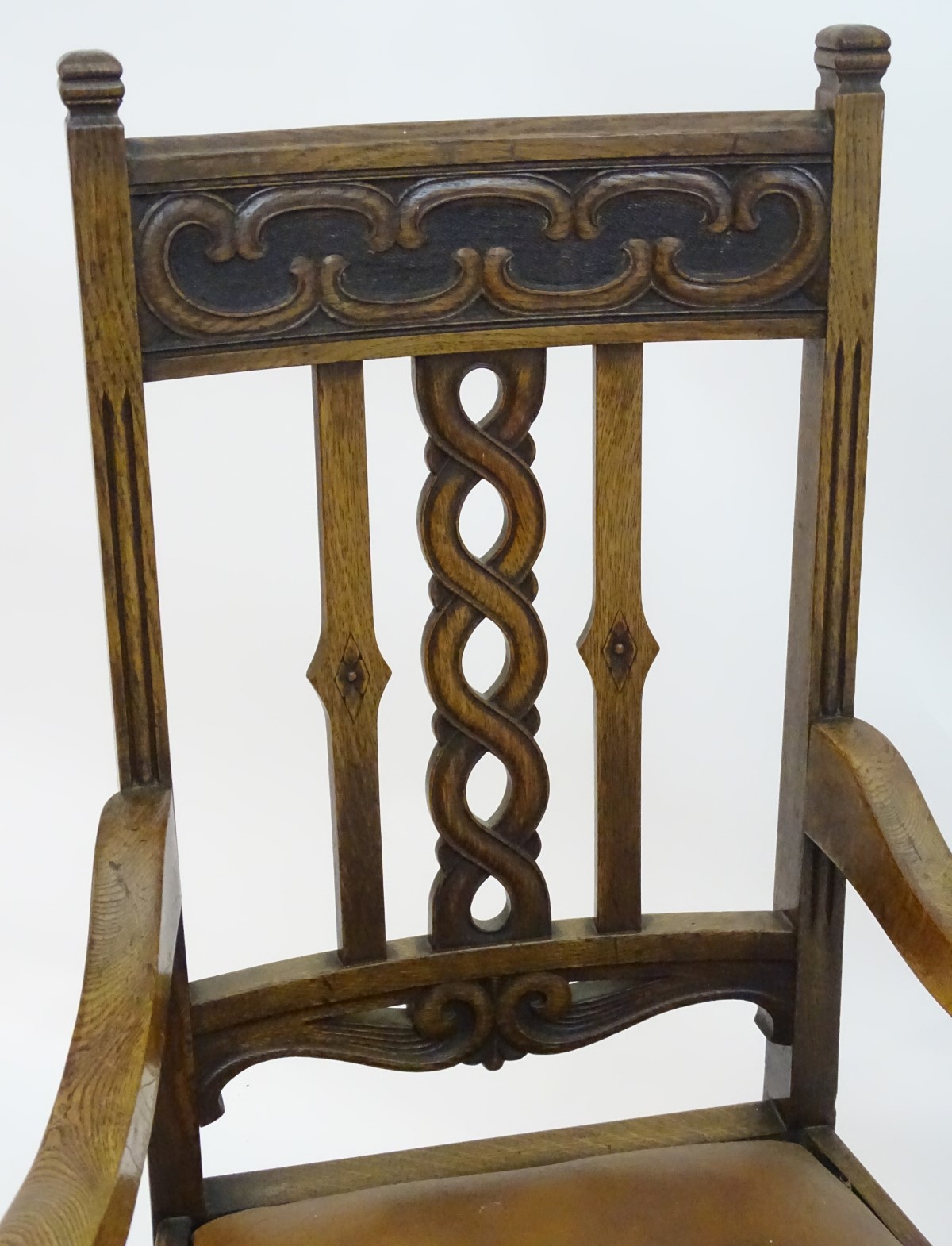 An early 20thC oak open armchair with a Celtic style carved top rail and back ress, - Image 3 of 8