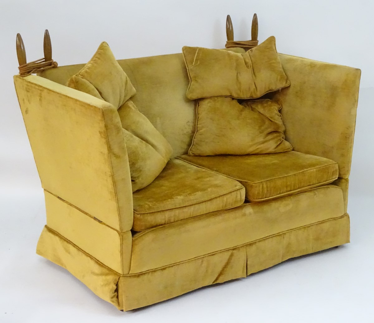 A mid / late 20thC two seater knole sofa with turned walnut finials and drop ends.